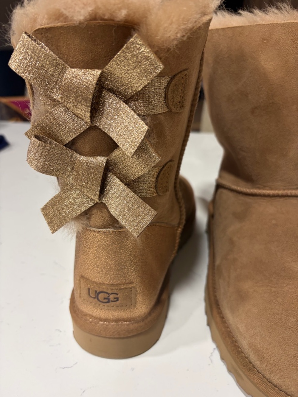 UGG Chestnut Suede Boots with Metallic Gold Bows
